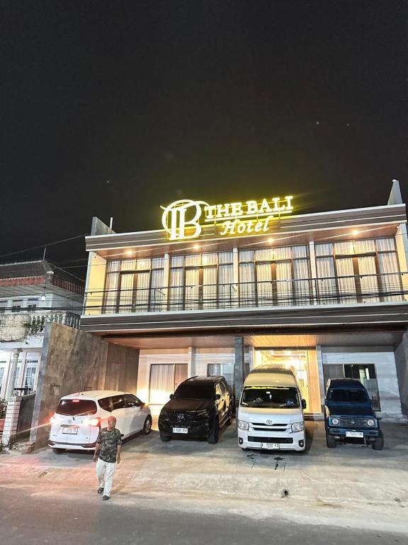 a building with cars parked in front of it at The Bali Hotel in Sumedang Utara