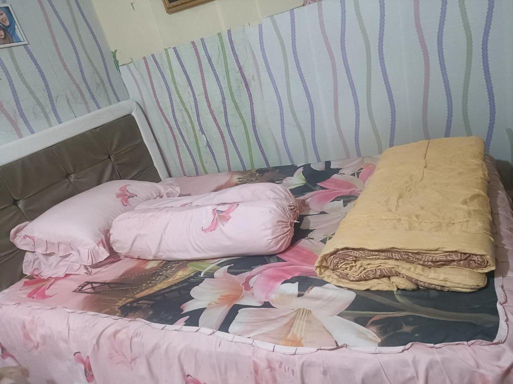 a bed with two pillows on it in a room at Kanaya house in Jakarta