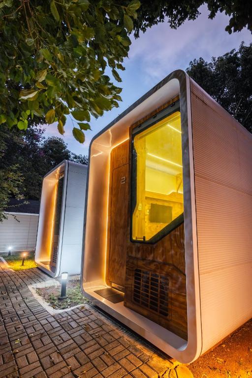 a couple of metal buildings parked next to each other at Green Garden Foz - Casas e Lofts em um Bosque in Foz do Iguaçu