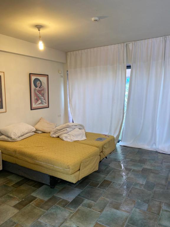 a bedroom with two beds and a window at יחידות ספיר in Ani'am