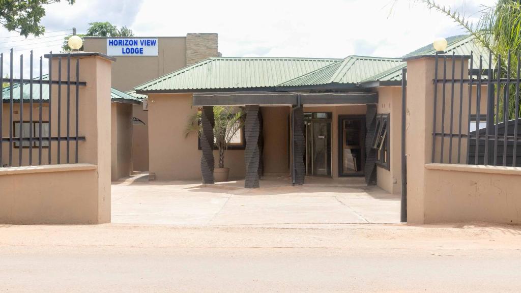 a building with a gate in front of it at The horizon view lodge in Chipata
