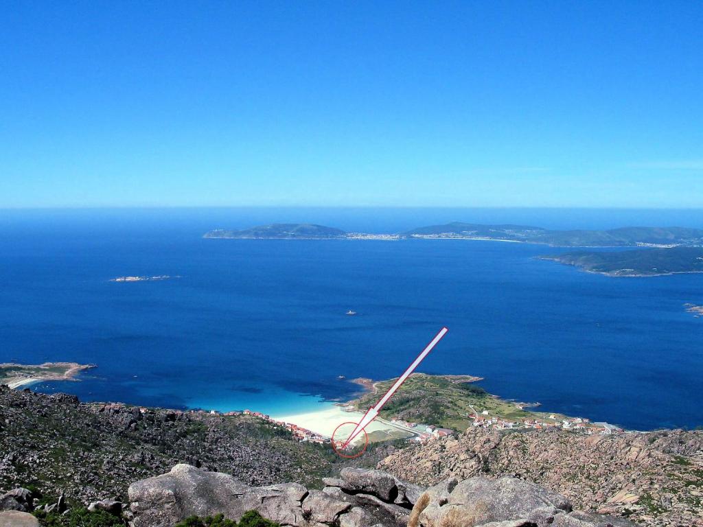 an aerial view of an island in the ocean at Apartamentos Playa Monte Pindo - Lobeira do Mar in O Pindo