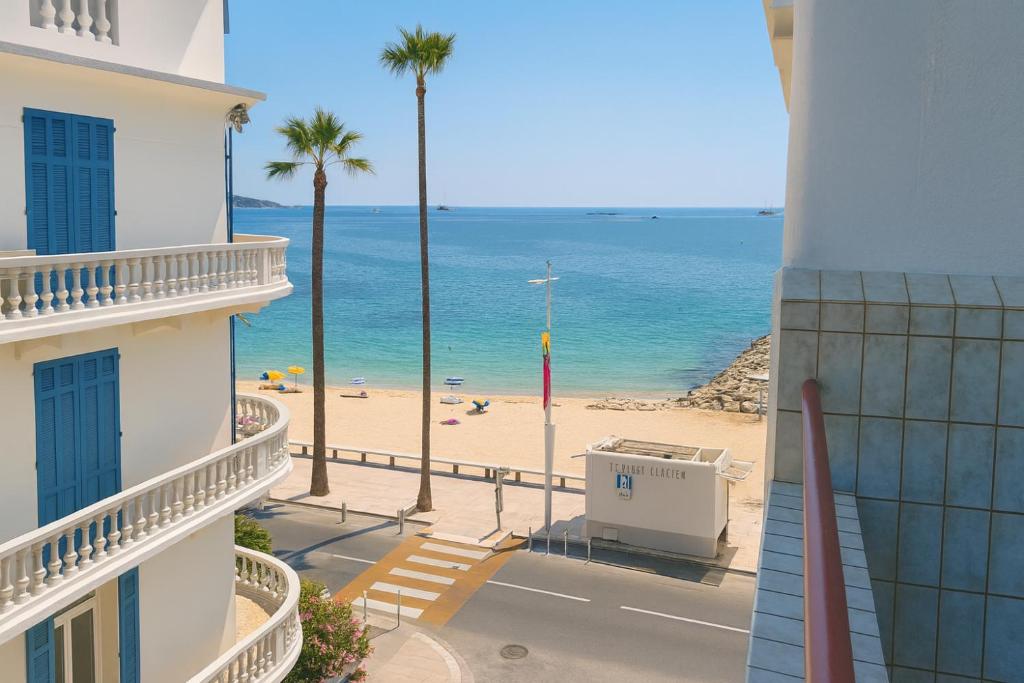 a view of the beach from the balcony of a building at Juan Signature in Juan-les-Pins