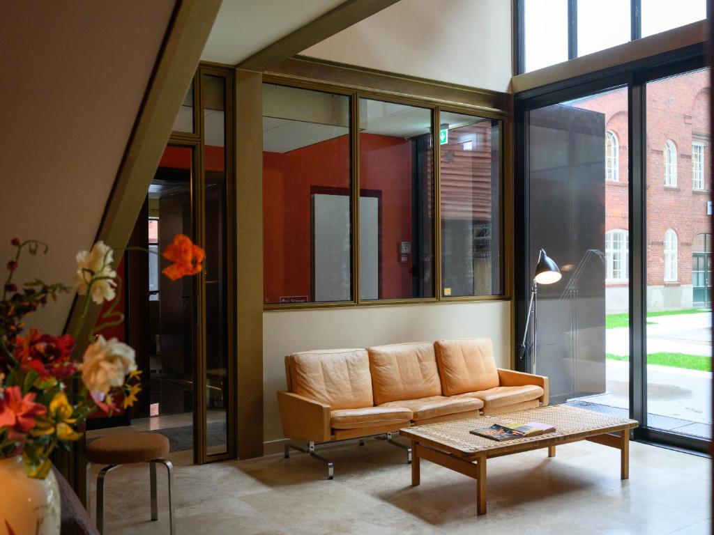 a living room with a couch and a coffee table at Hotel Frihavnen in Copenhagen