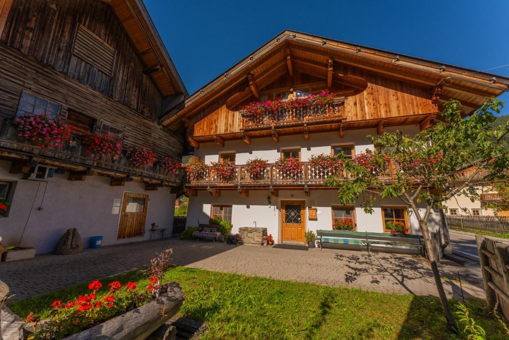 a building with flower boxes on the balconies of it at Untergisserhof in Sesto