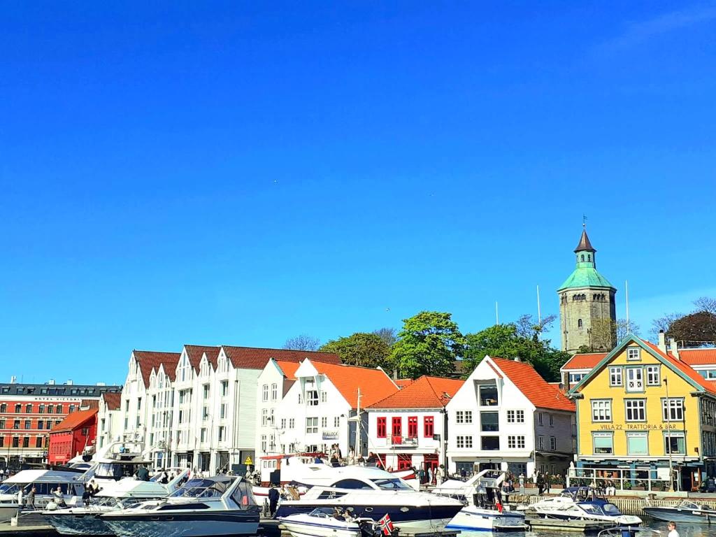a group of boats docked in a harbor with buildings at Dali City Senter Ap 2 in Stavanger