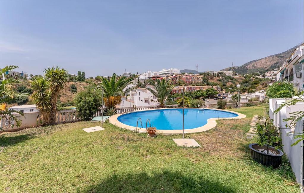 a swimming pool in the yard of a house at 3 Bedroom Cozy Home In Fuengirola in Torremuelle