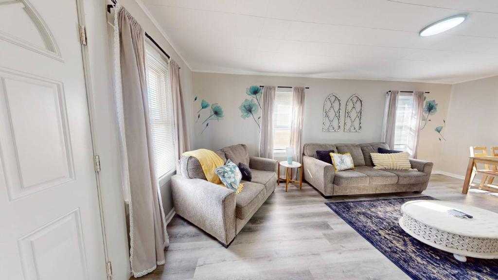 a living room with two couches and a table at 3 Bed 2 bath Pet Friendly in Historic Bates Hendricks in Indianapolis
