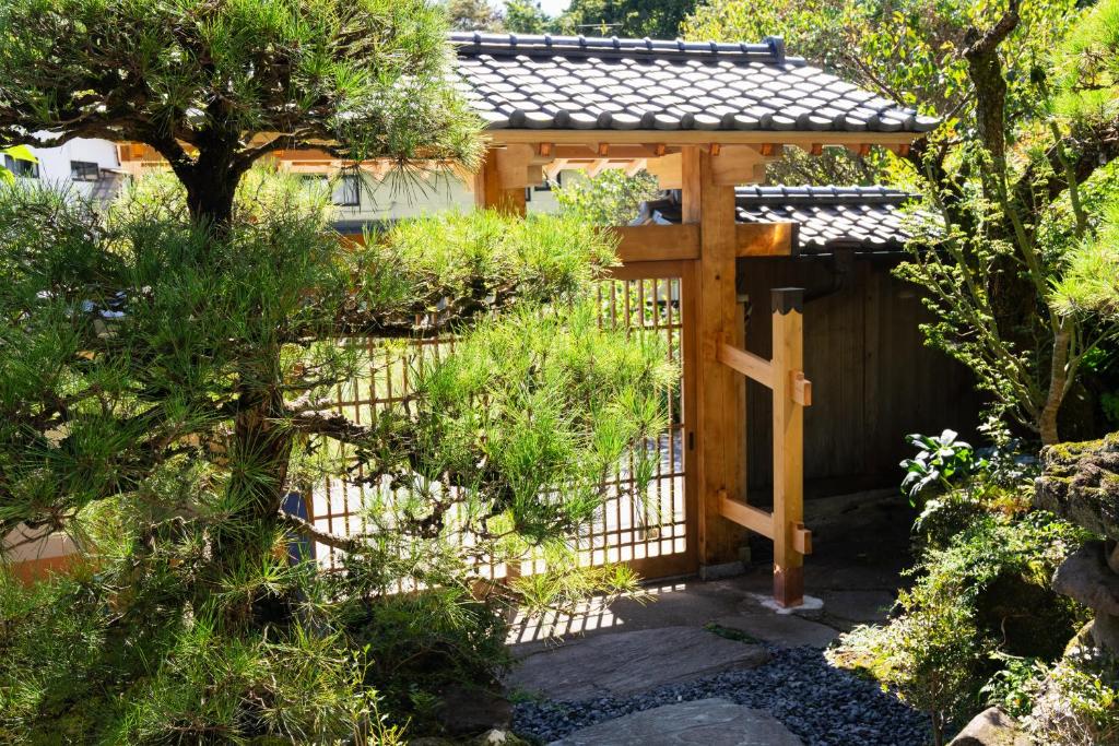 a wooden gazebo in the middle of a garden at 春日光 HaruNikko in Nikko
