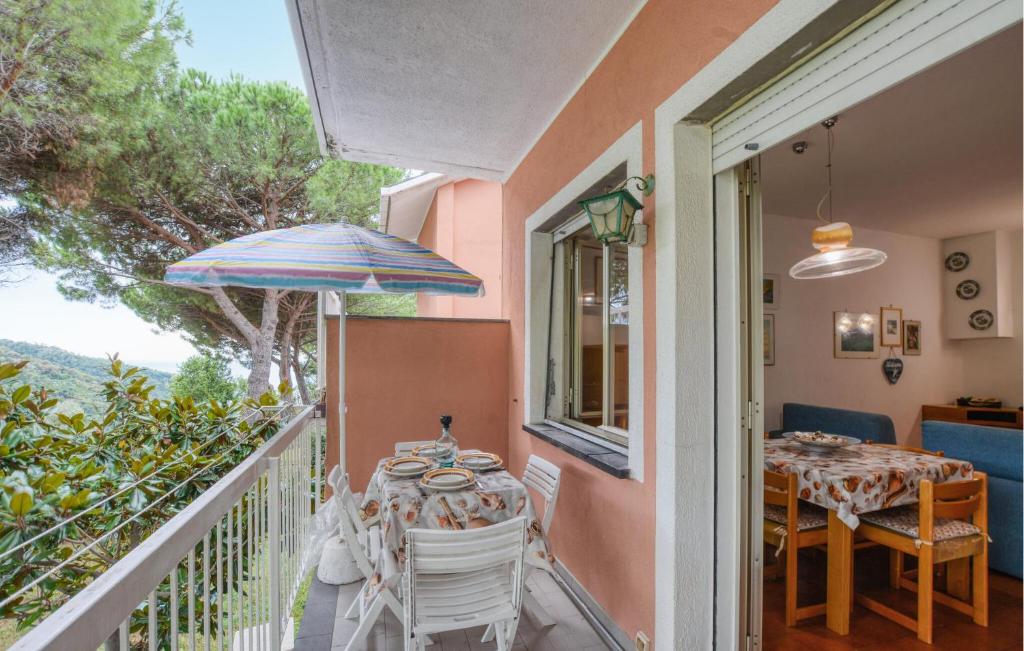 a balcony with a table and an umbrella at 1 Bedroom Awesome Apartment In San Saturnino in Bracco
