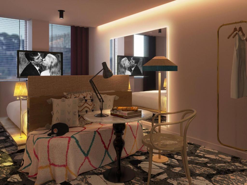 a bedroom with a bed and a table with a lamp at Mama Shelter Roma in Rome
