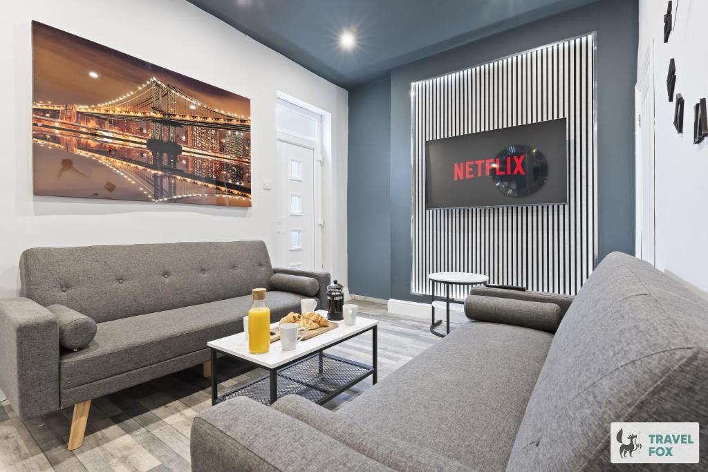 a living room with two couches and a tv at Bella's House 12mins bus to Motor Point Arena Free Street Parking in Nottingham