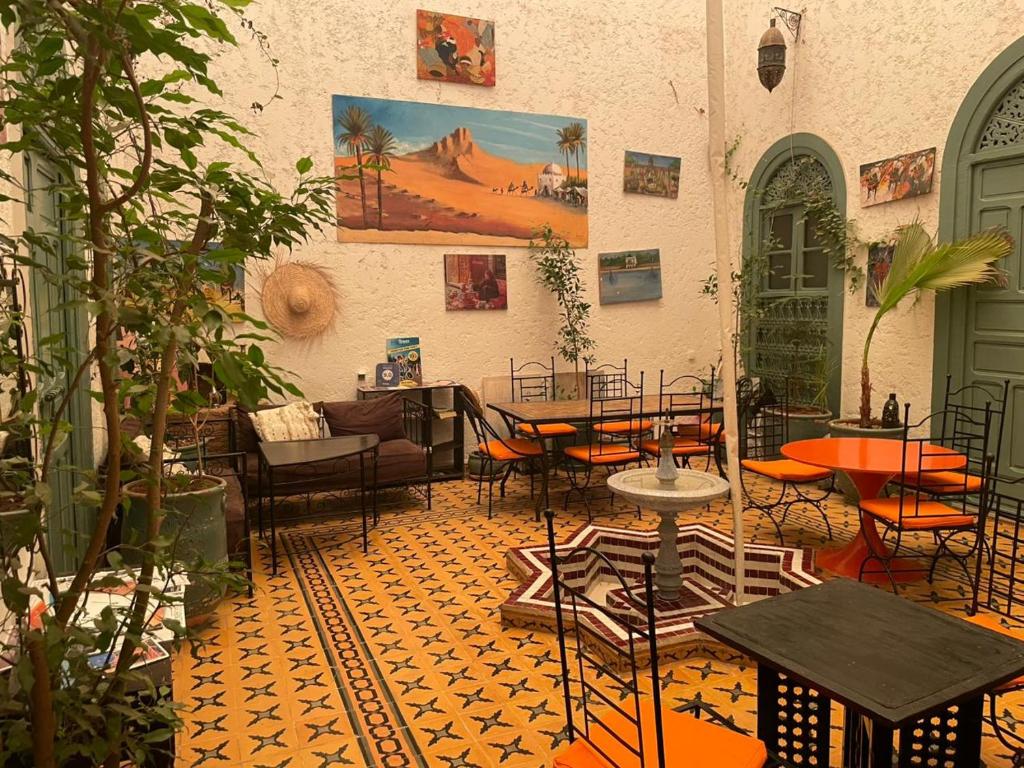 a patio with tables and chairs in a building at Dar JOMANA in Marrakech