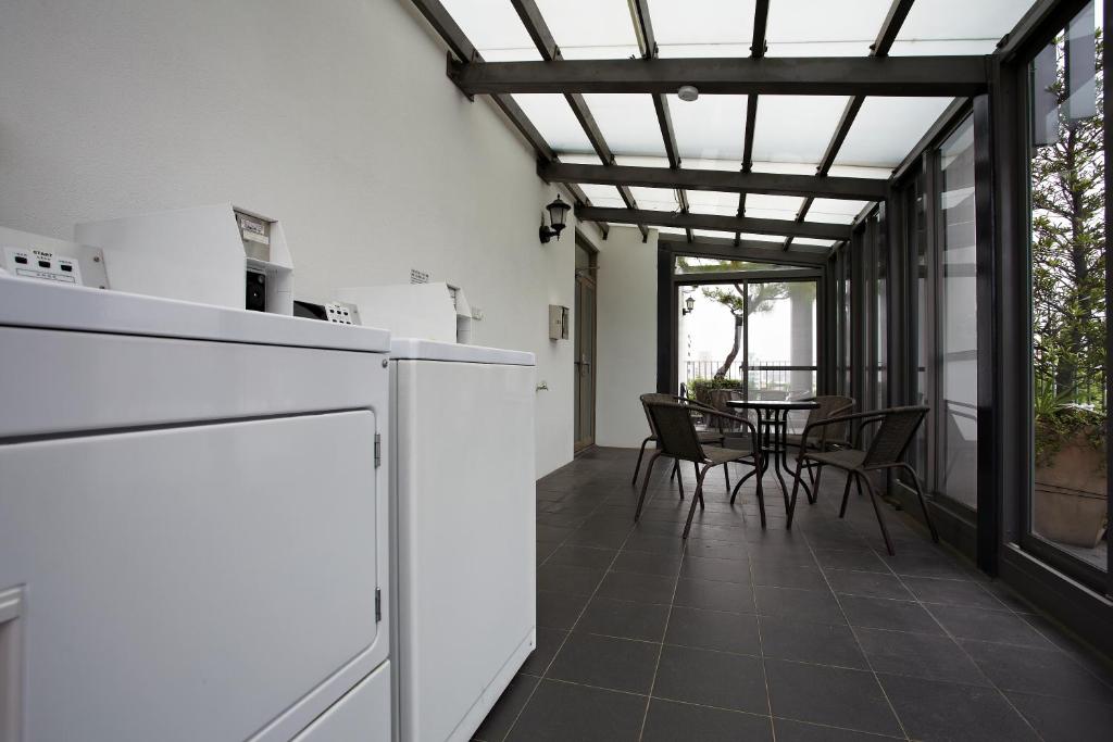 a kitchen and dining room with a table and chairs at Micasa Hotel in Taichung