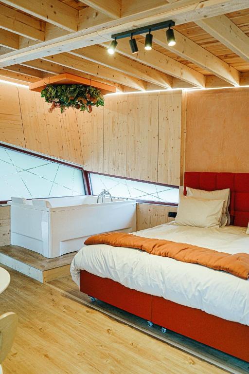 a bedroom with a bed in a room with wooden walls at Bobble in Mons
