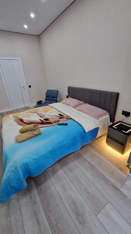 a bedroom with a large bed in a room at Апартаменты в ЖК Атамура in Karagandy