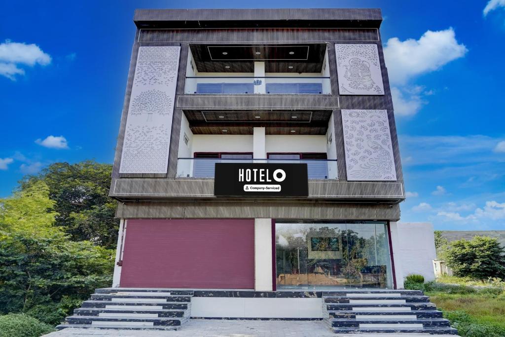 a tall building with a hello sign on it at Hotel O Mathura-Bharatpur Crossway Formerly Tulsi Heritage in Churaman Nagri