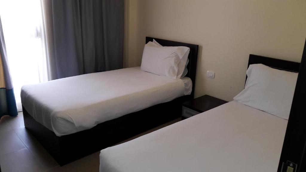 Postel nebo postele na pokoji v ubytování Mousa Coast Hotel & Spa