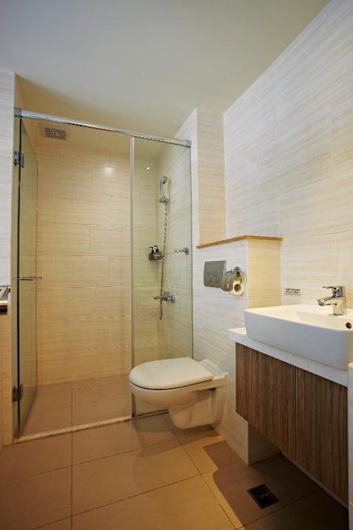 a bathroom with a shower and a toilet and a sink at Micasa Hotel in Taichung