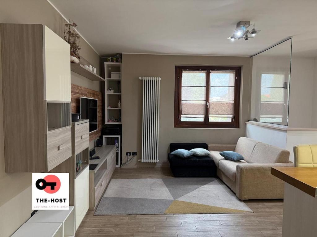 a living room with a couch and a table at Large apartment with garden and cinema room in Giussano