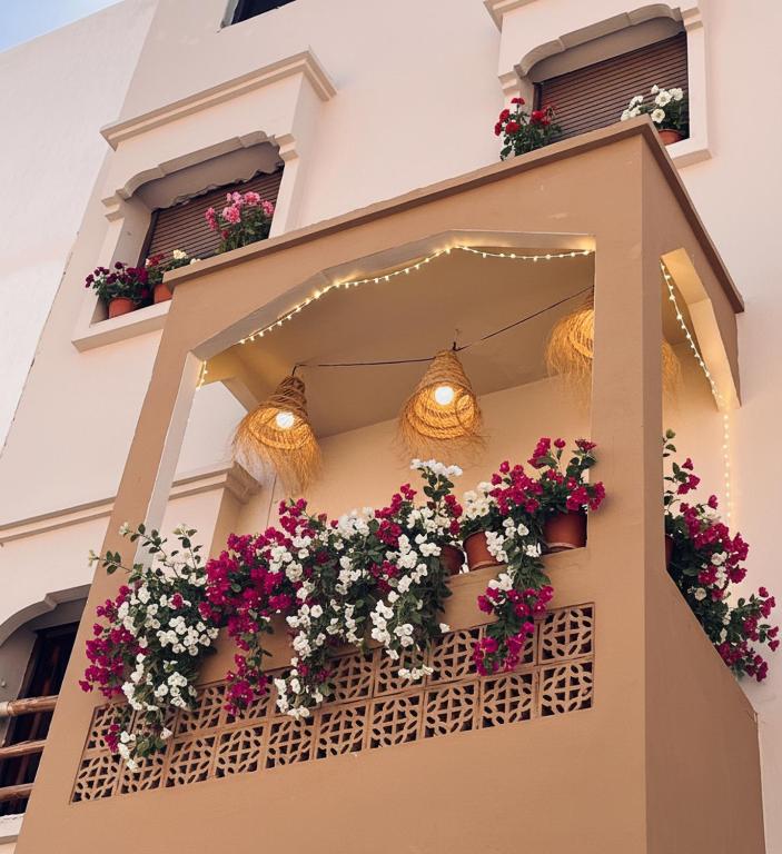 a building with flower boxes on a balcony at Wild Surf Morocco in Agadir