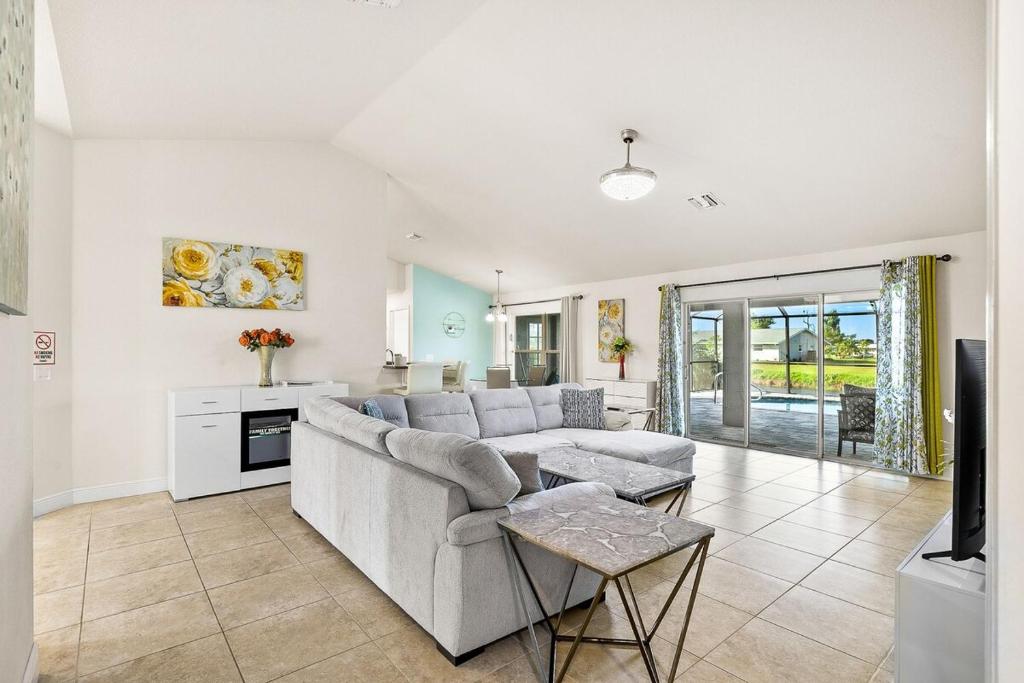 a living room with a couch and a tv at Newley Built Oasis Heated Pool Waterfront retreat in Rotonda West