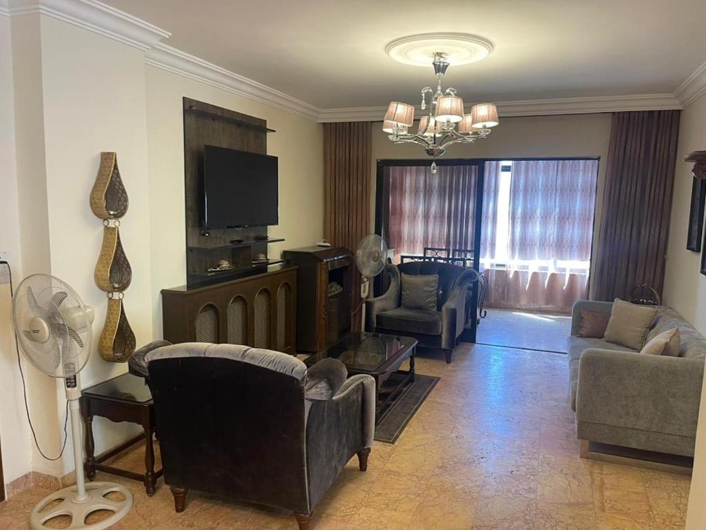 a living room with couches and a flat screen tv at Jubaiha Stars in Al Jafr