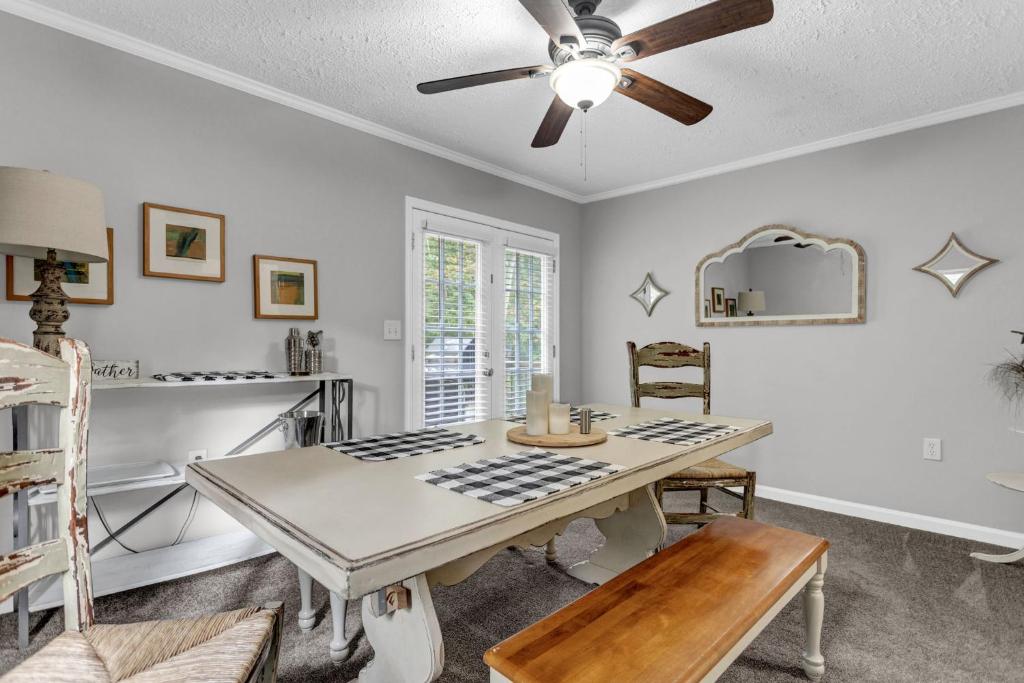 a dining room with a table and a ceiling fan at Grill & Chill Retreat in Acworth