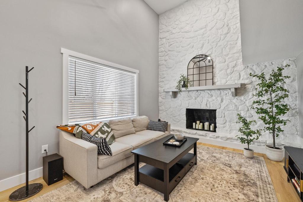 a living room with a couch and a fireplace at Hoosier Hq Sleek 3-bed Near Iu in Bloomington