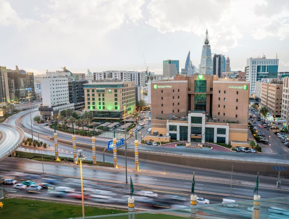 a city skyline with traffic on a highway at Holiday Inn Riyadh Olaya by IHG in Riyadh