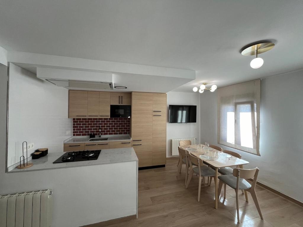 a kitchen and dining room with a table and chairs at Casa Collado Apartmento 2A in San Vicente