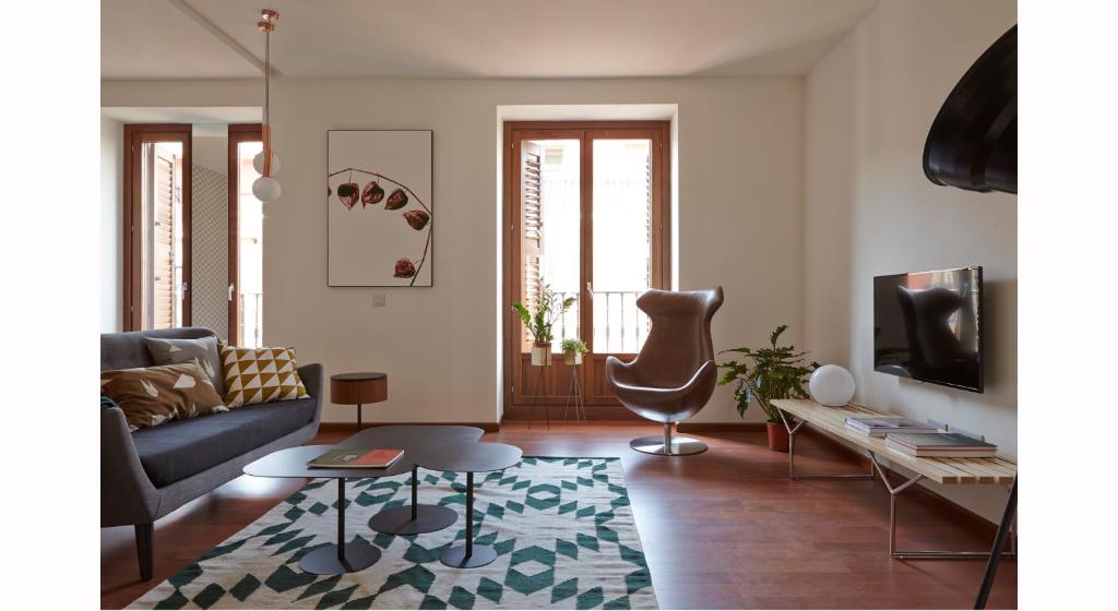 a living room with a couch and a table at 60 Balconies Design in Madrid