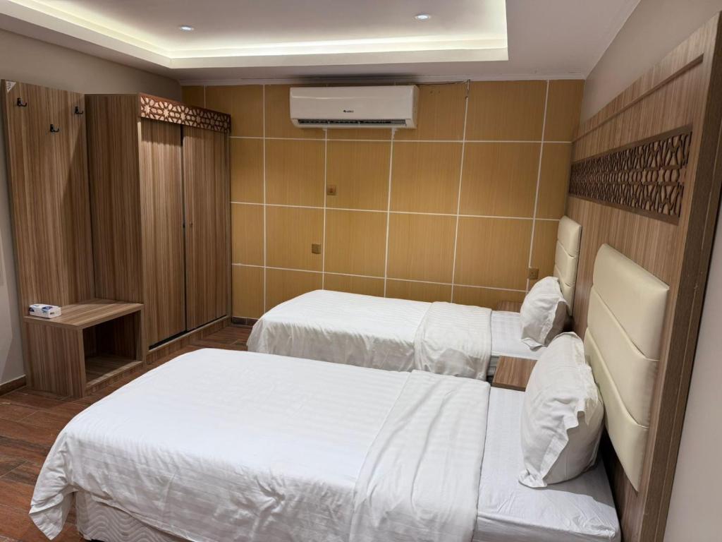 Postel nebo postele na pokoji v ubytování شقق مملكة كنان النسيم