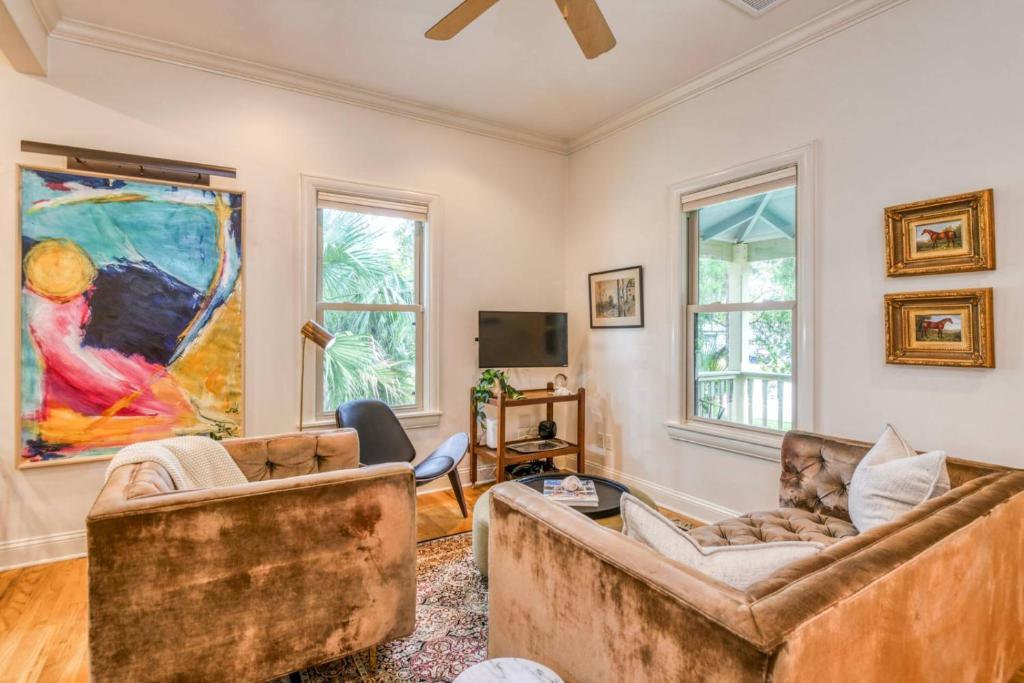 a living room with two couches and a tv at Little Blue Cottage in St. Augustine