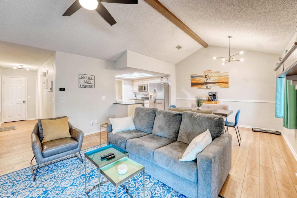a living room with a couch and a table at Modern Bentonville Retreat - Sleeps 6 Near Trails in Bentonville