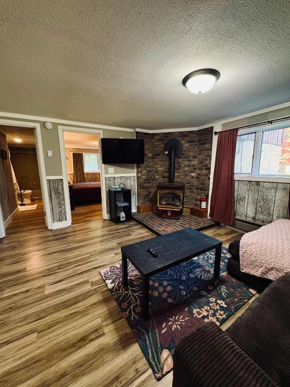 a living room with a couch and a fireplace at Fall Getaway in Auvinen Corner