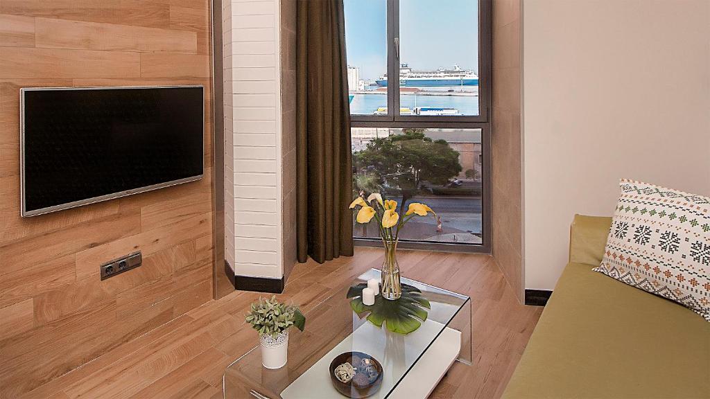 Televízia a/alebo spoločenská miestnosť v ubytovaní Apartamentos Suites Oficentro Deluxe