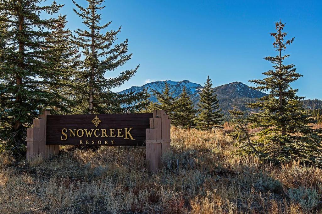a sign in the middle of a field with trees at Snowcreek #059 Near Shuttle & Activities in Mammoth Lakes