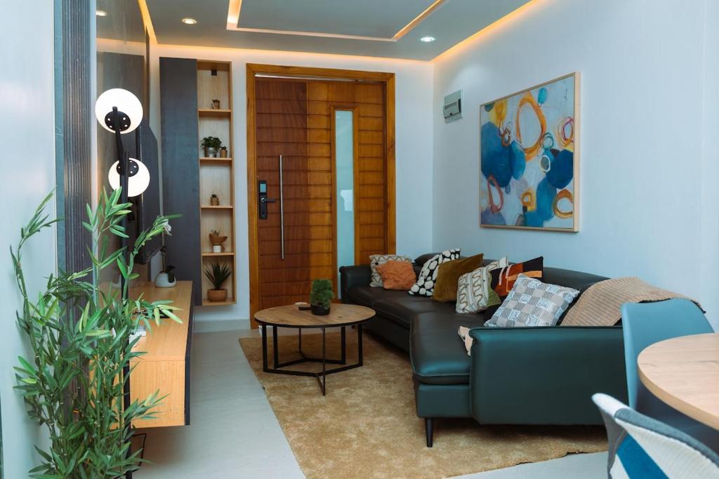 a living room with a couch and a table at Bigchillstruth Apt in Accra