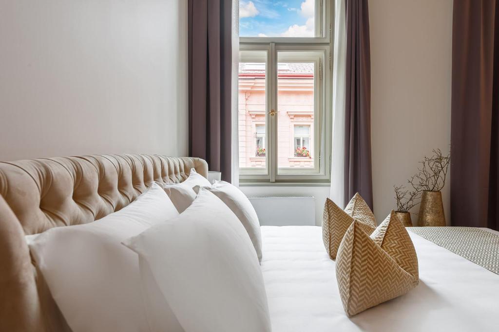 a hotel room with two beds and a window at H7 Palace in Prague