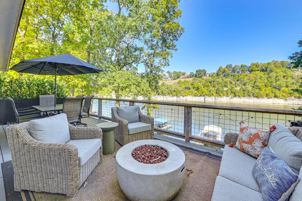 a patio with chairs and a table and an umbrella at Herrington Lake Retreat with Dock, 1 Mi to Marina! in Bushtown