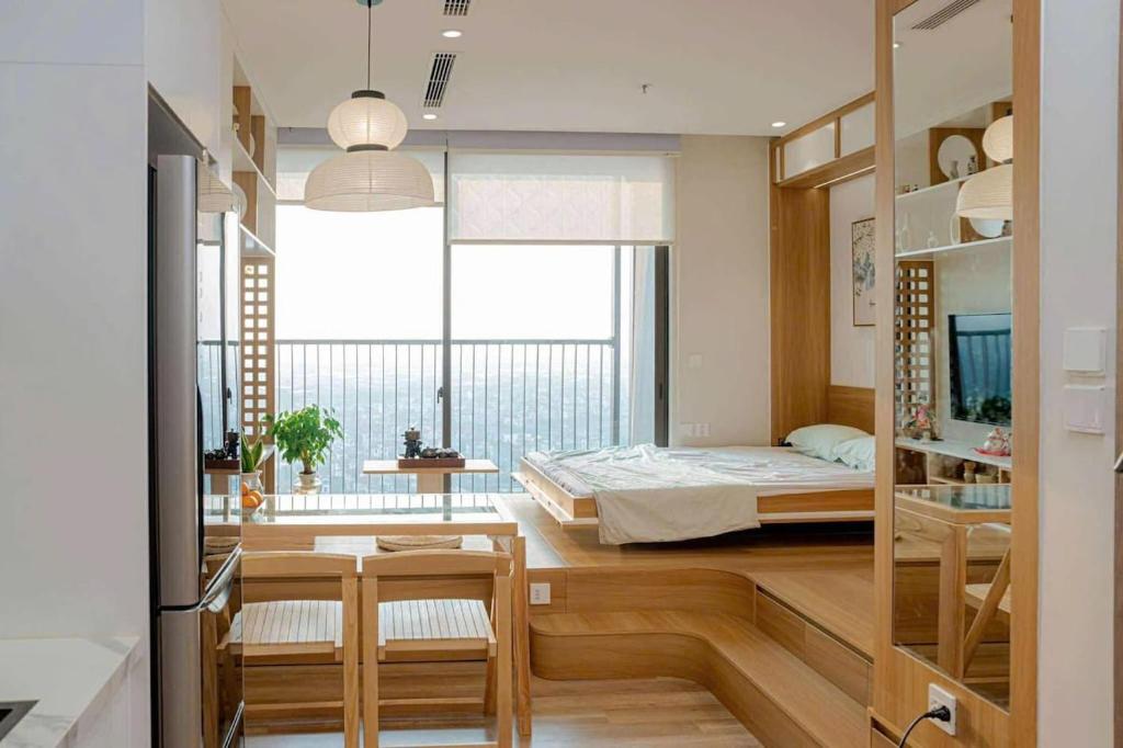 a room with a bed and a bedroom with a window at Fuji Room Ở Space Ecopark in Kim Quan