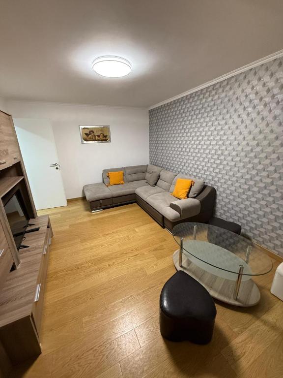 a living room with a couch and a glass table at Apartament Bibi in Făgăraş