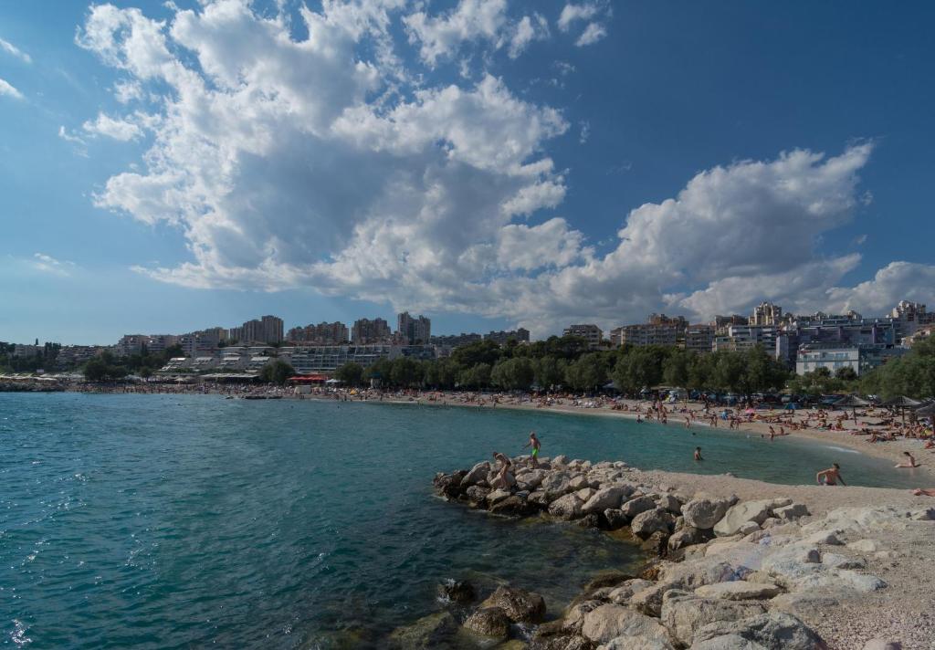 a group of people on a beach near the water at Luxury Rooms Near the Beach in Split