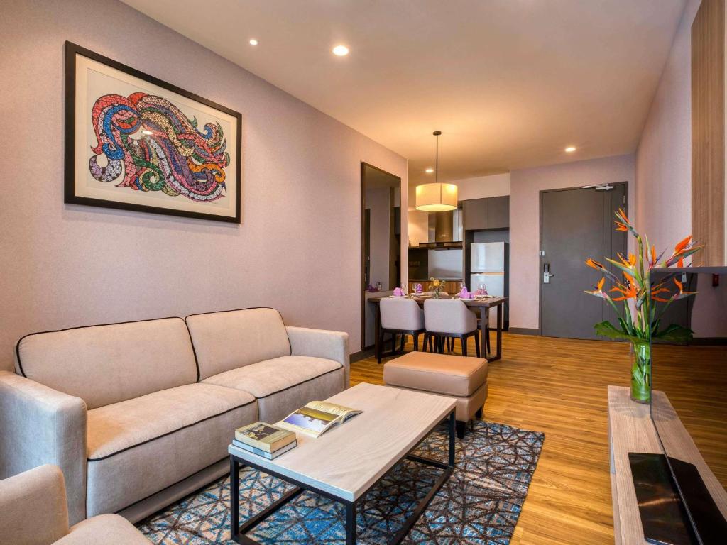 a living room with a couch and a table at Mercure Living Putrajaya in Putrajaya