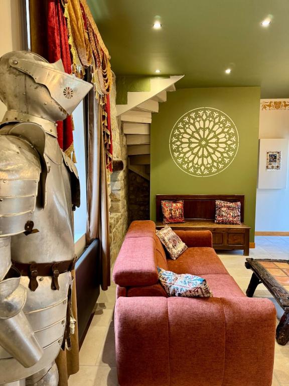 a living room with a couch and a chair at maison climatisée à thème médiéval avec baignoire balnéothérapie in Sens