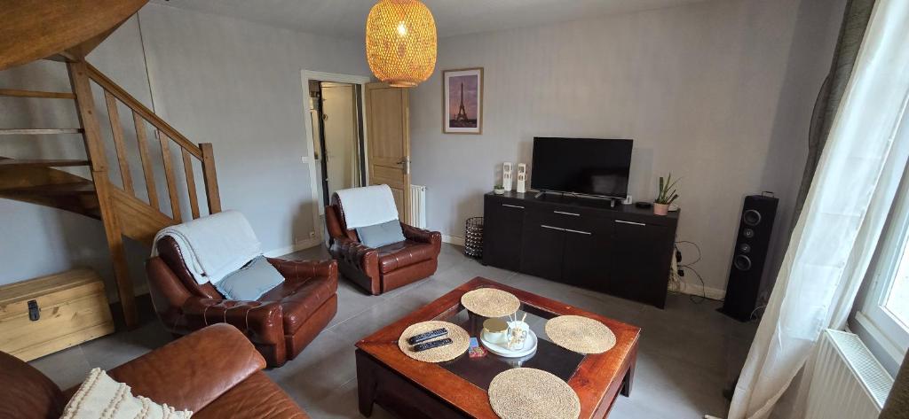 a living room with a couch and a table at Appartement Le Saint Julien centre historique in Chartres