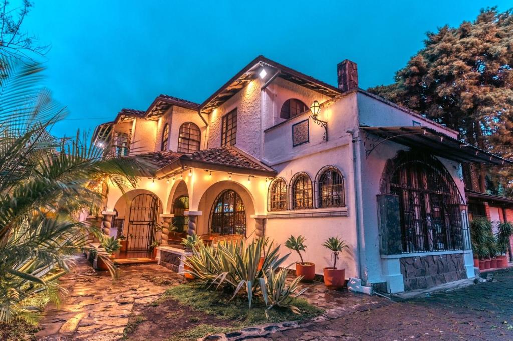 an old house with lights on it at night at awā San José in San José