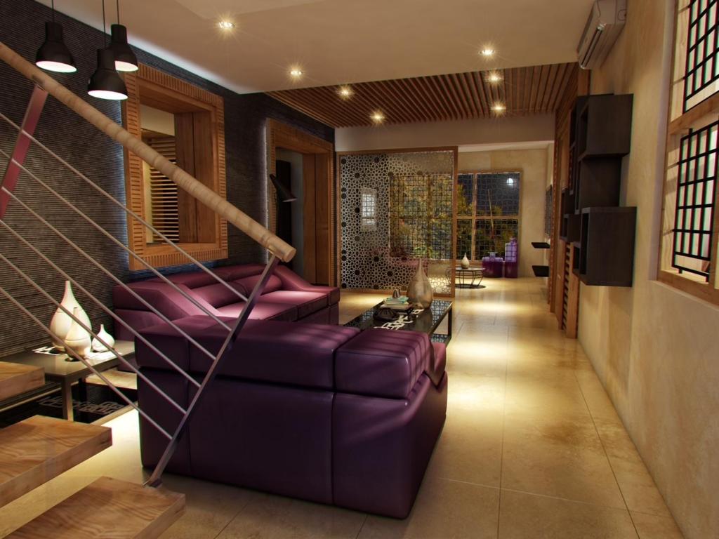 - un salon avec un canapé violet dans l'établissement Yasuragi Boutique Resort, à Shencottah