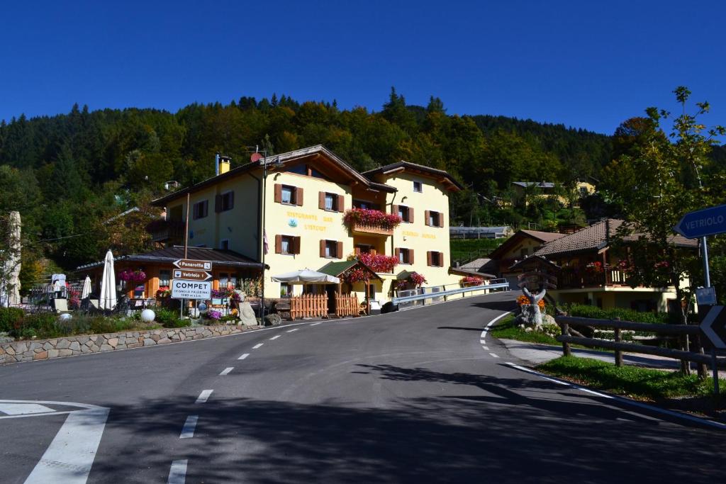 an empty road in a village with a building at Albergo Aurora in Vignola